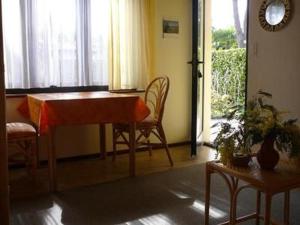 a living room with a table and chairs and a window at Casa Adelizia in Ascona
