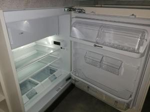 an empty refrigerator with its door open in a kitchen at Casa Adelizia in Ascona