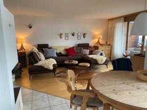 a living room with a couch and a table at Wohnung Schluein in Schluein +25 photos
