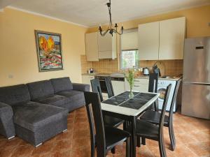 a kitchen and living room with a couch and a table at Villa Rolla in Tivat