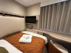 a hotel room with a bed and a flat screen tv at Mabledon Court Hotel in London