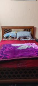 uma cama com um edredão roxo em cima em Charming Chennai Home with Modern Amenities em Chennai