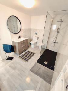 a bathroom with a sink and a toilet and a mirror at Vivenda Montanha - Relax in Nature in Alcaria