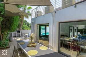 an outdoor dining area with a table and chairs at Villa Chic Romance by Abahana Villas in Fanadix