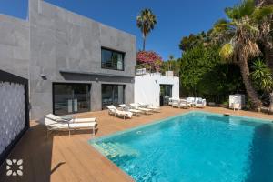 a swimming pool in front of a house at Villa Chic Romance by Abahana Villas in Fanadix