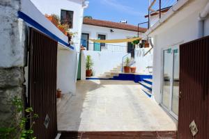 a narrow alley with blue and white buildings at Vivenda Montanha - Relax in Nature in Alcaria +37 photos