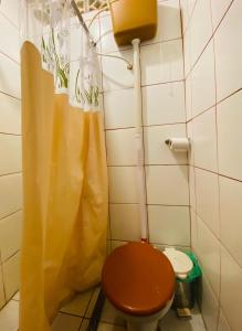 a bathroom with a toilet and a shower curtain at Kasa Krom in Belém