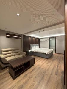 a large bedroom with a bed and a couch at Plaza 14 in Jammu +15 photos