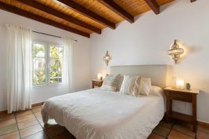 a bedroom with a white bed and a window at Casa Strelitzia by Escape Home in Nazaret +32 photos