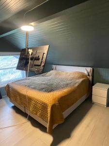a bedroom with a bed with a desk on it at Arctic villa with ocean view, jacuzzi and northern lights in Karlsøy