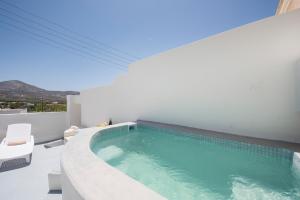 a swimming pool in the middle of a house at Villa Aegeon Grande in Megalochori