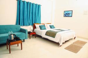 Un dormitorio con una cama y un sofá azul. en Solis Stay, en Solapur