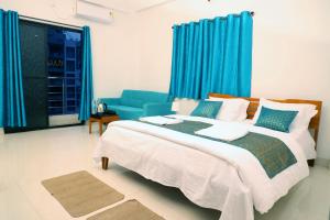 a bedroom with a bed and a blue couch at Solis Stay in Solapur
