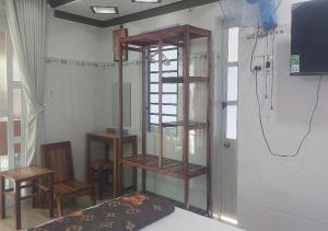 a room with wooden shelves on the wall at Biển Ngọc Homestay - Ngay sát biển Phan Rang in Bắc Sớn
