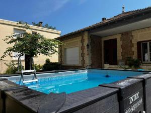 a swimming pool in front of a house at Villa septembre logement VANILLE in Lamalou-les-Bains