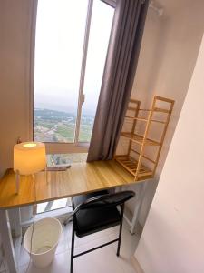 a room with a desk with a large window at Tokyo River side PIK2 By Micky Studio 3 in Muara