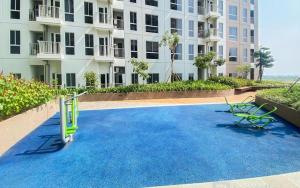 an apartment patio with a playground and a building at Tokyo River side PIK2 By Micky Studio 3 in Muara