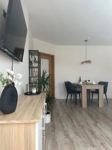 a living room with a table and a dining room at Stayaire in Schönebeck
