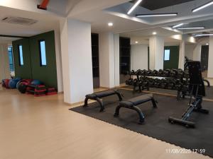 a gym with treadmills and weights in a room at Executive Antara Homestay Putrajaya near PICC, UITM Dengkil in Putrajaya
