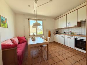 a living room with a couch and a table in a kitchen at Gästehaus Sonne in Zuchwil