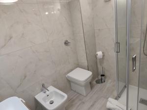 a bathroom with a shower and a toilet and a sink at Corte Antica Marsala in Marsala +9 photos