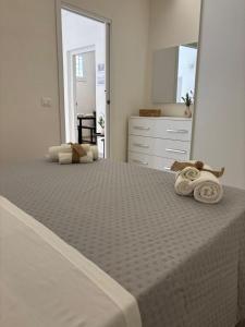a bedroom with a large bed with towels on it at Corte Antica Marsala in Marsala