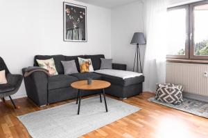 a living room with a couch and a table at Ferienwohnung Panoramablick - super für deine Familie und die besten Aussicht in ganz Todtmoos in Todtmoos