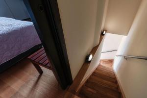 a small room with a bed and a chair at Grace Suite with Jacuzzi Wonderful Lakefront View in Colonno