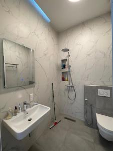 a white bathroom with a sink and a toilet at Keur Moussa in Dakar +24 photos