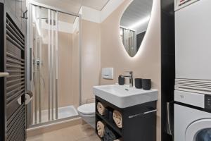 a bathroom with a sink and a toilet at Alpine Gem - AC - FreeParking - LakeBeach 8min drive in Altdorf