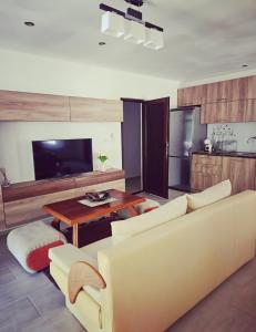 a living room with a couch and a table at Къща за гости Вила Чифлици in Chiflik