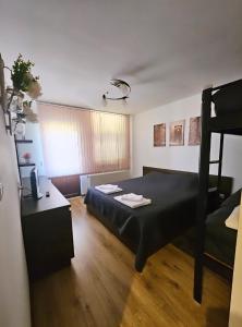a bedroom with a bed and a bunk bed at Къща за гости Вила Чифлици in Chiflik +18 photos