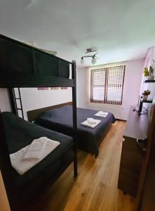 a bedroom with two bunk beds and a desk at Къща за гости Вила Чифлици in Chiflik
