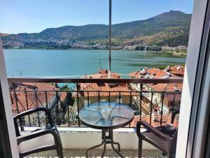a table on a balcony with a view of a lake at Konstantina's Sky View in Kastoria