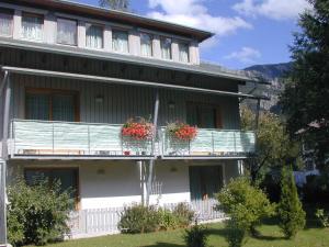 a building with two balconies with flowers on it at Wanderhotel Grüner Baum in Bach