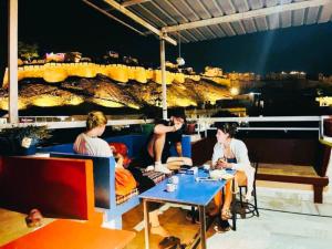 a group of people sitting at a table on a patio at Heritage Haveli Jaisalmer in Jaisalmer