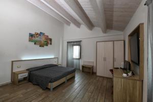 a bedroom with a bed and a flat screen tv at Cantina Langelina in Corinaldo