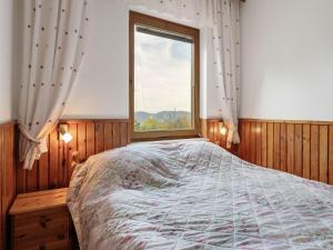 a bedroom with a large bed and a window at Alpine Hut in Eberstein near Ski Area in Eberstein