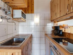 a small kitchen with a sink and a stove at Alpine Hut in Eberstein near Ski Area in Eberstein
