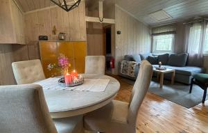 a living room with a table with candles on it at Holmsjøhytta in Sjørbotn