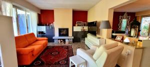 a living room with orange furniture and a fireplace at Einzelzimmer mit Gemeinschaftsbad -und Küchenbenutzung in Purasca