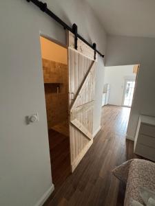 an open door in a room with wooden floors at Studio proche de Jonzac in La Celle-sous-Gouzon