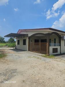 a house with a large garage with a driveway at Homestay Sarah Ali Kuantan 3BEDROOM 2WASHROOM SELESA,BERSIH & LUAS in Kuantan