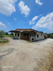 a large white building with a garage at Homestay Sarah Ali Kuantan SELESA,BERSIH & LUAS in Kuantan