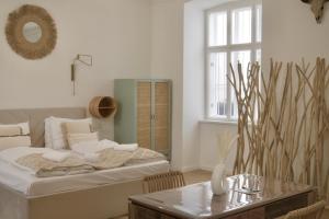 a bedroom with a bed and a table and a window at City Stay Vienna – Stephansdom in Vienna