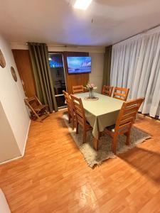 a dining room with a table and chairs at Casa Cypresses in Temuco