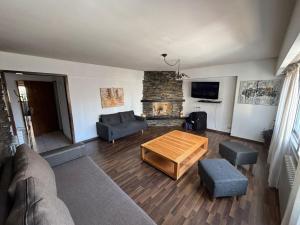 a living room with a table and a fireplace at Piso villegas in San Carlos de Bariloche