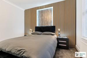 a bedroom with a large bed and a window at Liz's 4 Bed House: Close to the Motor Point Arena in Nottingham