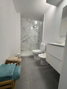 Un baño blanco con inodoro y ducha. en Casa Giorì playa de las Americas, en Playa de las Américas