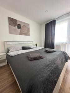 a bedroom with a bed with two towels on it at Apartmánový byt Bakossova in Banská Bystrica
